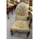 19th cent. Mahogany framed nursing chair, with woolwork upholstery, short carved cresting rail,
