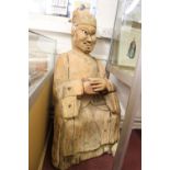 Chinese: Large Chinese Ming Dynasty treen Taoist seated figure with original paint residue 48ins.