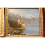 Continental School: Oil on canvas a Chateau by a hillside lake, gilt framed 24ins. x 20ins.