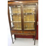 19th cent. Mahogany display cabinet, lead glazed in an Art Nouveau style, 2 drawers below on slender