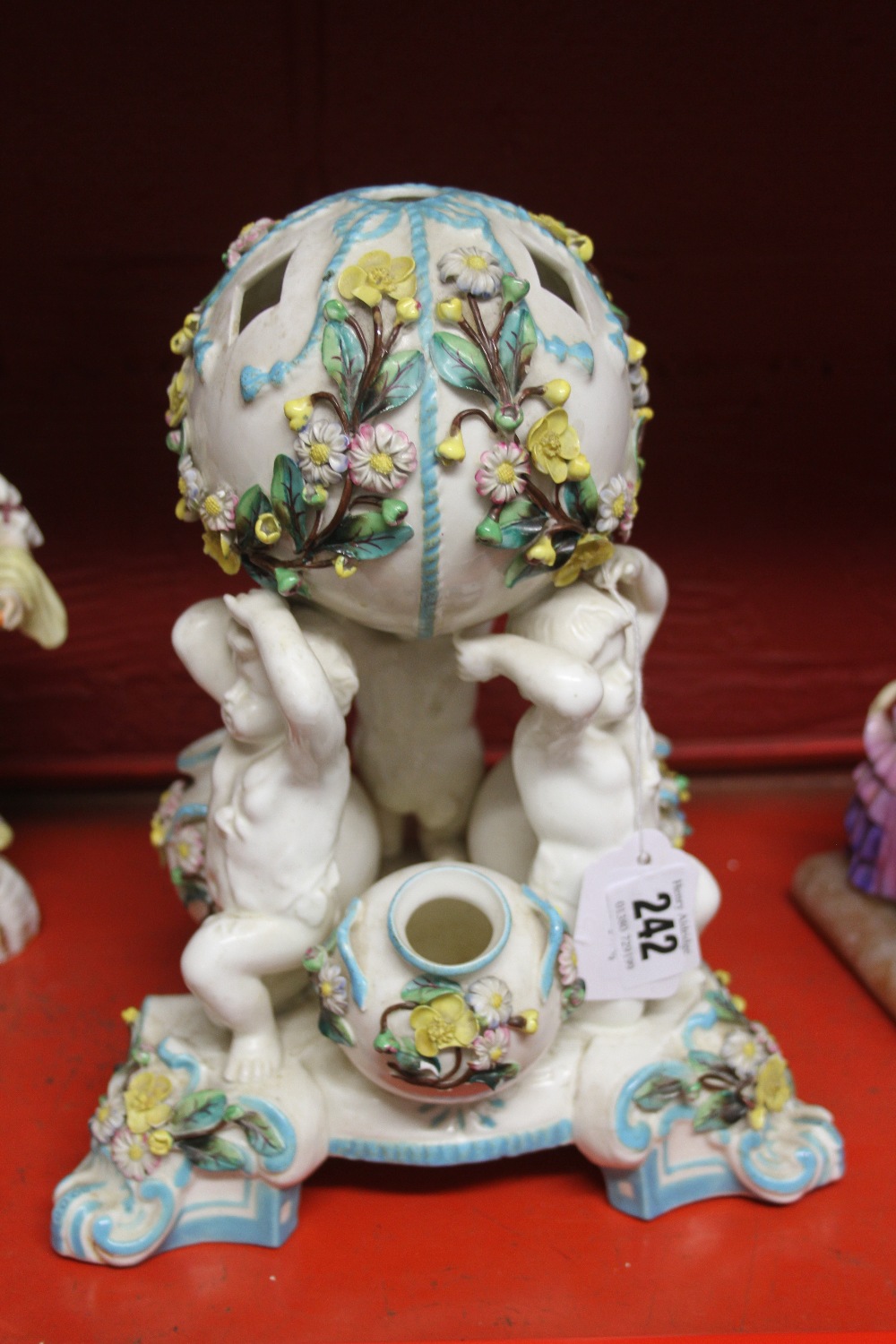 19th cent. Ceramics: Table centre piece possibly Minton, in the form of four cherubs supporting a