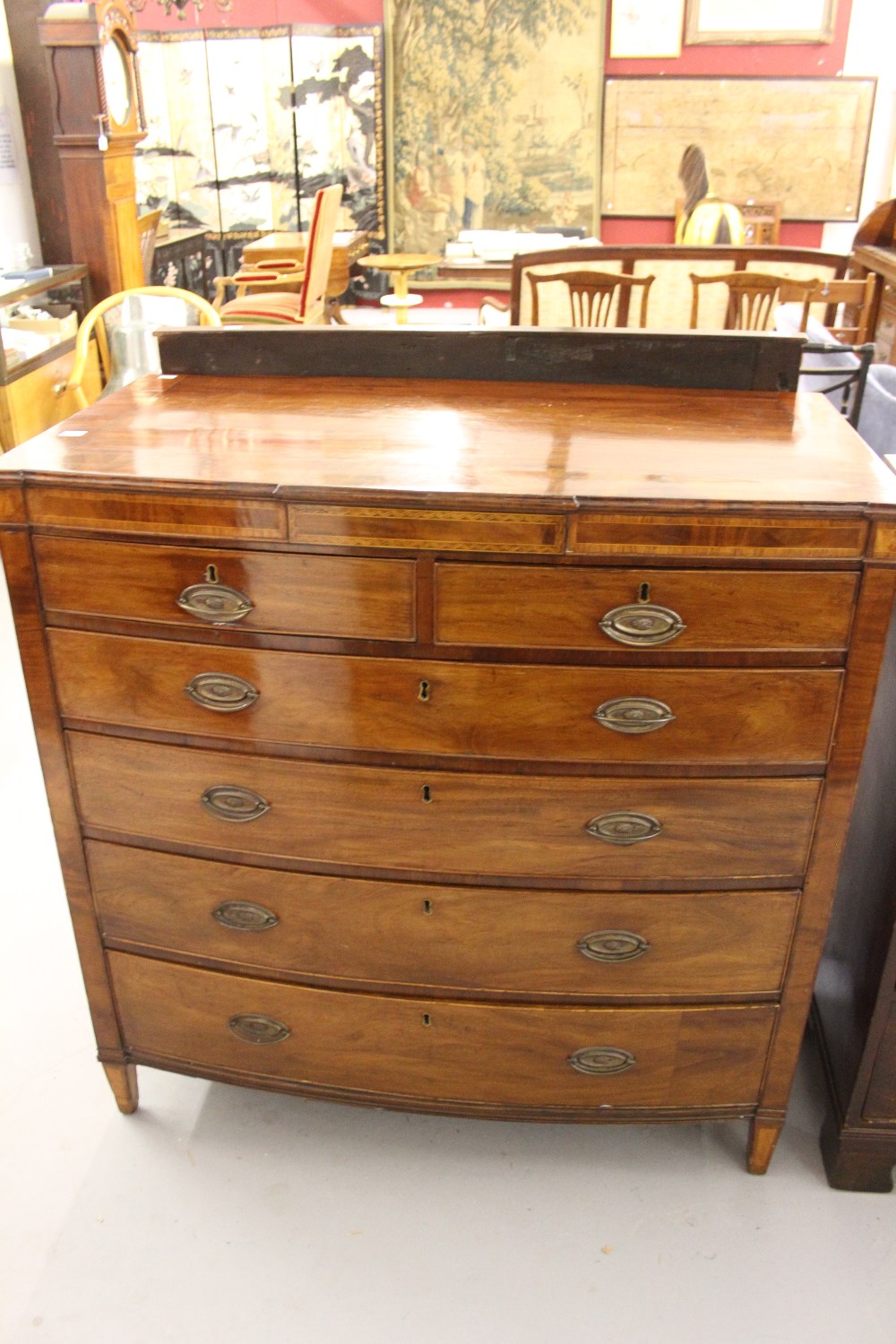 19th cent. Mahogany bow fronted chest of drawers with inlaid panel decoration, 2 short and 4 long