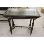 Late Victorian ebonised card table, circa 1885, the hinged rectangular top with a canted edge