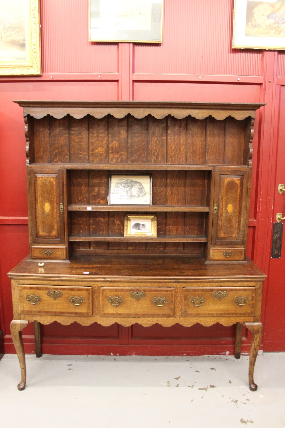 George III oak dresser on subtle cabriole support. The base has three drawers to the front each with