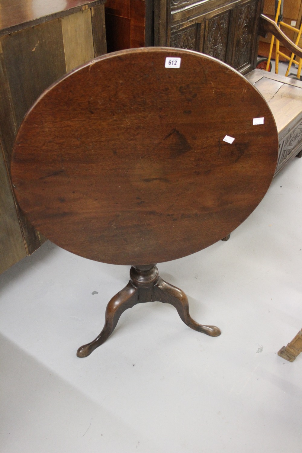 Late George III provincial mahogany tripod table, c1815, the circular top on a baluster turned