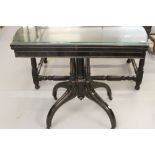 Late Victorian ebonised card table, circa 1880, the hinged shaped rectangular top with a moulded
