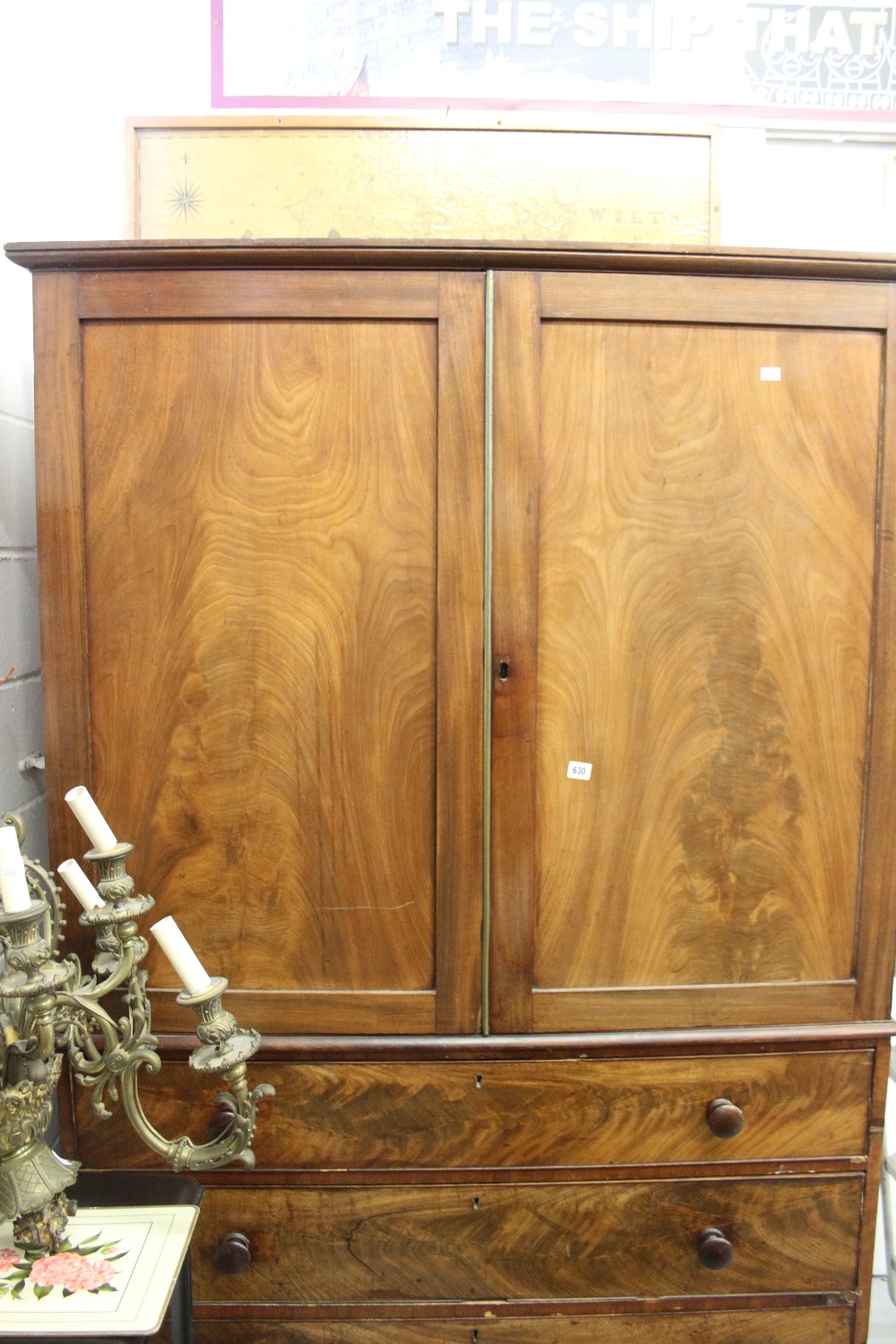 19th cent. Figured mahogany linen press with 4 slides over 3 graduated drawers.