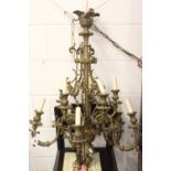 Late 19th century brass nine-branch chandelier, the reeded column and scrolled bird cage stem
