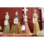 Dolls: Clothes brush dolls, one holding flowers, one deco wearing a cloak, one deco wearing green
