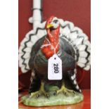 20th cent. Ceramic figurine of a bronze turkey in display. 8½ins. x 6ins. x 6ins.