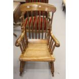 Mid Victorian walnut rocking chair, c1860, the bobbin turned back with a shaped top rail and