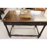 18th cent. Oak side table on turned gun barrel supports. Long drawer front & frieze has carved