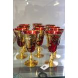 20th cent. Glassware: Ruby red hock glasses with gilt enamel decoration. (11 Glasses).