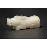 A Celadon Jade Chi Tiger, Mid-Western Zhou Dynasty 西周中期螭琥 A Hetian celadon jade figure in round. The