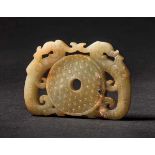 A Chukuo Bi-disc with ‘Double Dragons’ Motif, Han Dynasty 漢代乳丁紋出廓雙龍璧 Width 8.2 cm, height 5.7 cm.