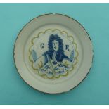 George I: an English (probably Bristol) Delft plate painted in blue, green and orange with a half-