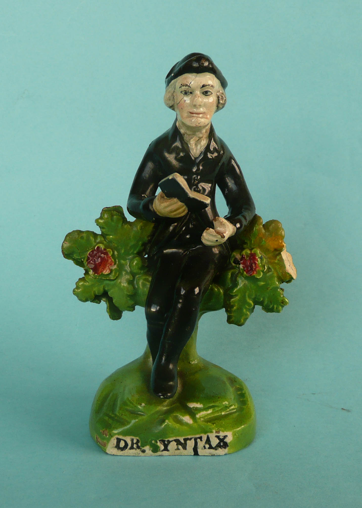 Dr Syntax: an early-19th century Staffordshire pottery figure on named base, 140mm, restored (