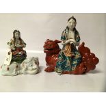 TWO KUTANI FIGURES - MEIJI FIGURE - GHANYIN ON FOO DOG AND 25CM AND GHANYIN SEATED ON ELEPHANT,