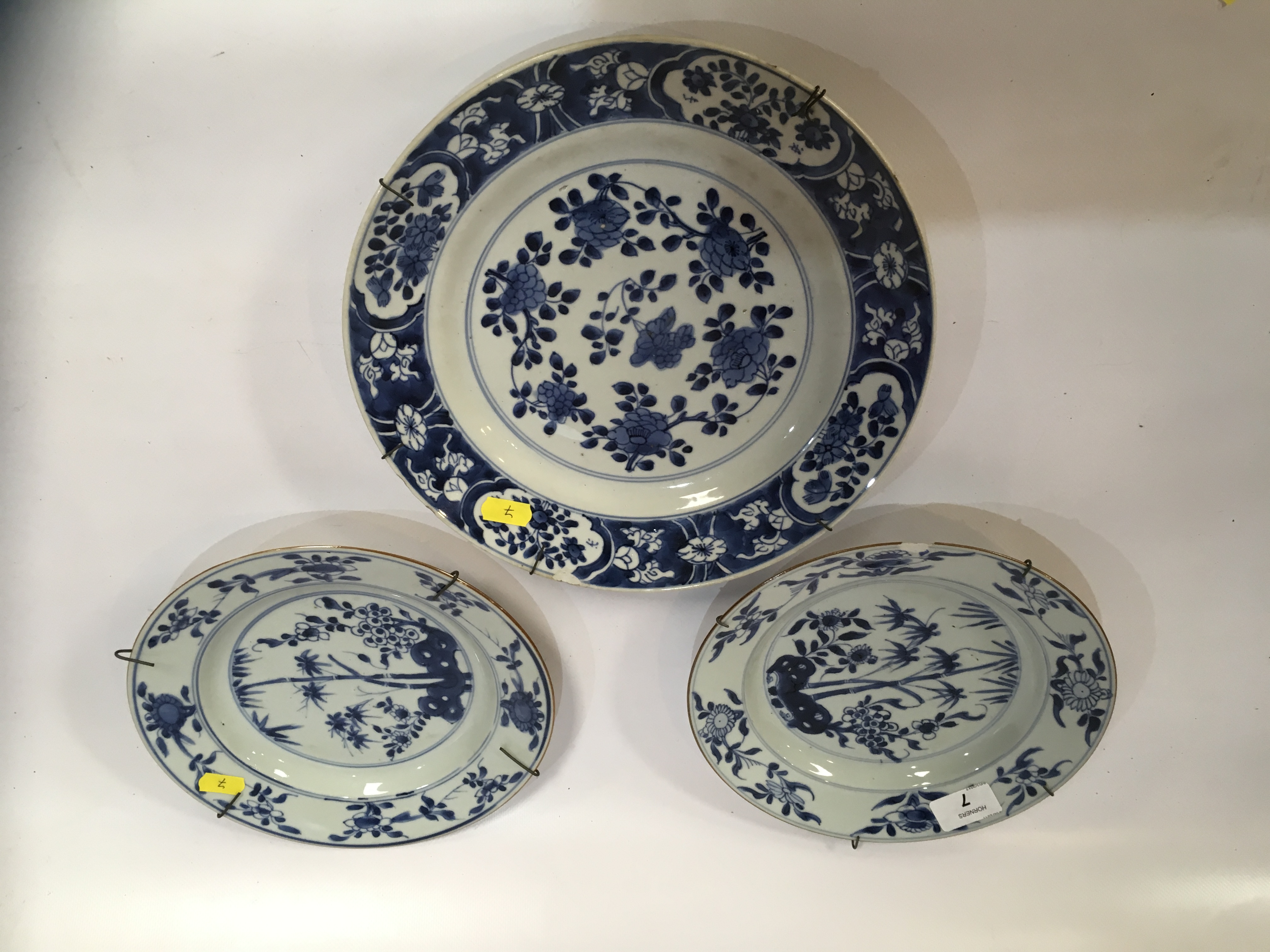 PAIR QIANLONG BLUE AND WHITE PLATES DECORATED WITH BAMBOO AND FLOWERS (ONE CHIPPED) ALONG WITH BLUE