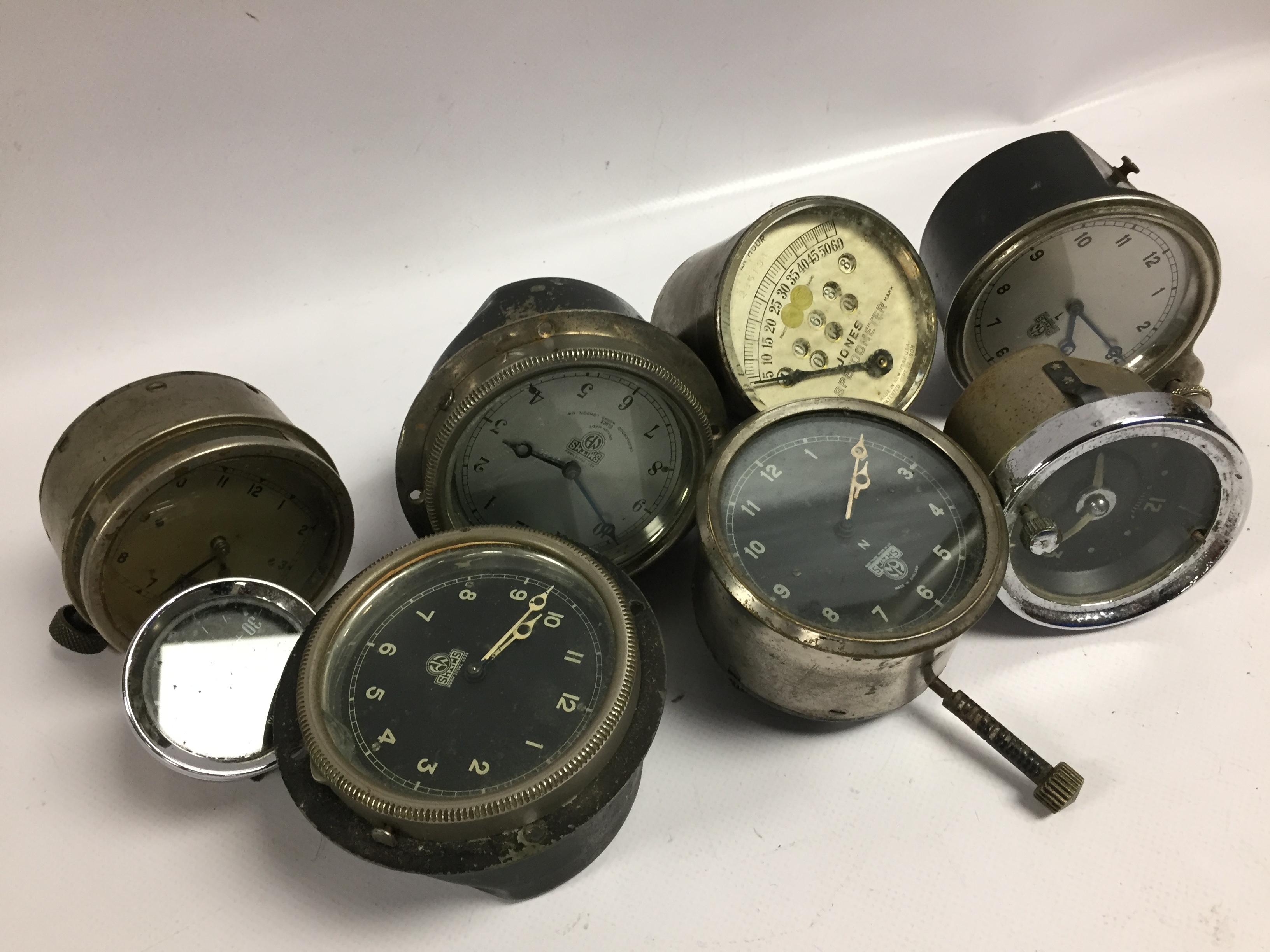 FIVE VINTAGE CAR CLOCKS AND A SPEEDOMETER