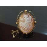 SHELL CAMEO ' ANGEL' MOUNTED IN AN ORNATE 9CT GOLD FRAME WITH SAFETY CHAIN AND PIN.