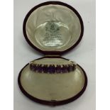 A JOHN BROGDEN (1851-1867) AMETHYST BANGLE - 9 IMPRESSIVE LARGE AMETHYSTS SET IN A GOLD MOUNT.