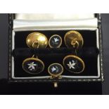 EDWARDIAN 15CT GOLD ENAMELLED CUFF LINK AND DRESS STUD SET DECORATED WITH A LILLY DESIGN.