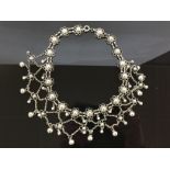 A DESIGNER WHITE METAL BALL AND CHAIN CHOKER NECKLACE.