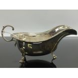 A SILVER SAUCE BOAT WITH GADROONED RIM,