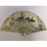 A C19TH IVORY FAN , THE PAPER LEAF PAINTED WITH FETE CHAMPETRE (AFTER WATTEAU),