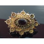 VICTORIAN GARNET SET MOURNING BROOCH WITH GLAZED BACK.