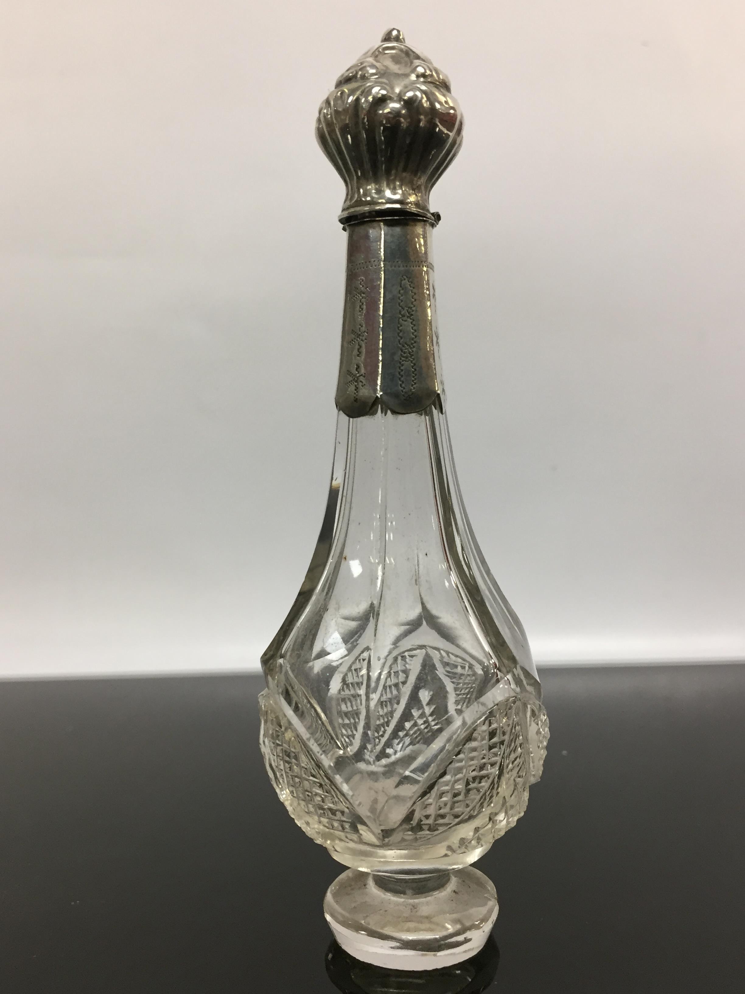 A SILVER AND GLASS SCENT BOTTLE WITH HINGED SILVER STOPPER AND SLEEVE, RUBBED HALLMARKS,