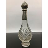 A SILVER AND GLASS SCENT BOTTLE WITH HINGED SILVER STOPPER AND SLEEVE, RUBBED HALLMARKS,