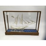 ORNATE WHITE METAL SHIP IN FITTED GLASS DISPLAY CASE