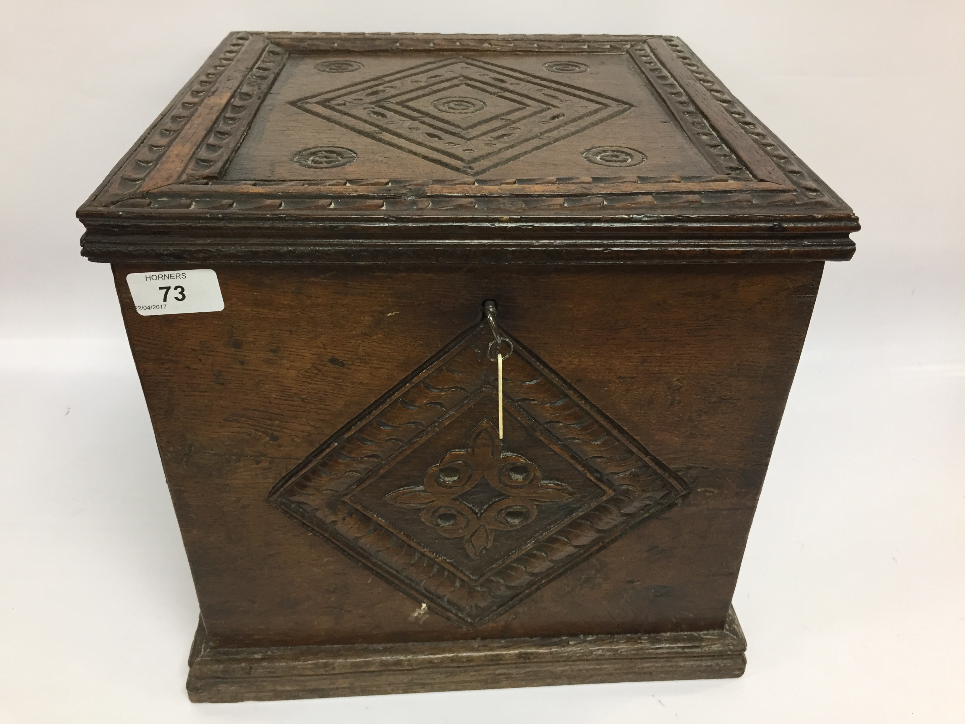 AN OAK SILVER CABINET WITH CARVED DETAIL