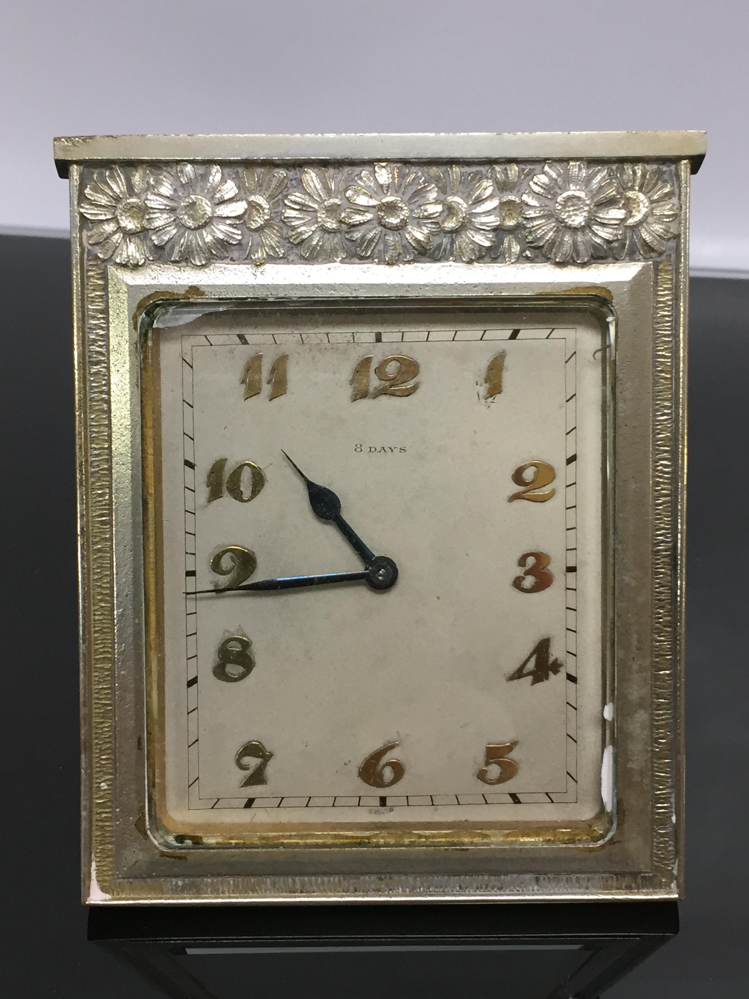 A SWISS WHITE METAL SQUARE DESK CLOCK IN ART DECO STYLE, FLORAL DECORATION TO TOP BORDER.