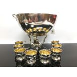 A SILVER PLATED PUNCH BOWL ON WARMING STAND COMPLETE WITH BURNER AND A PUNCH CUPS BY K ANDERSON.