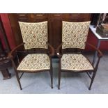 A PAIR OF EDWARDIAN MAHOGANY ARM CHAIRS UPHOLSTERED IN FLORAL TAPESTRY EFFECT MATERIAL