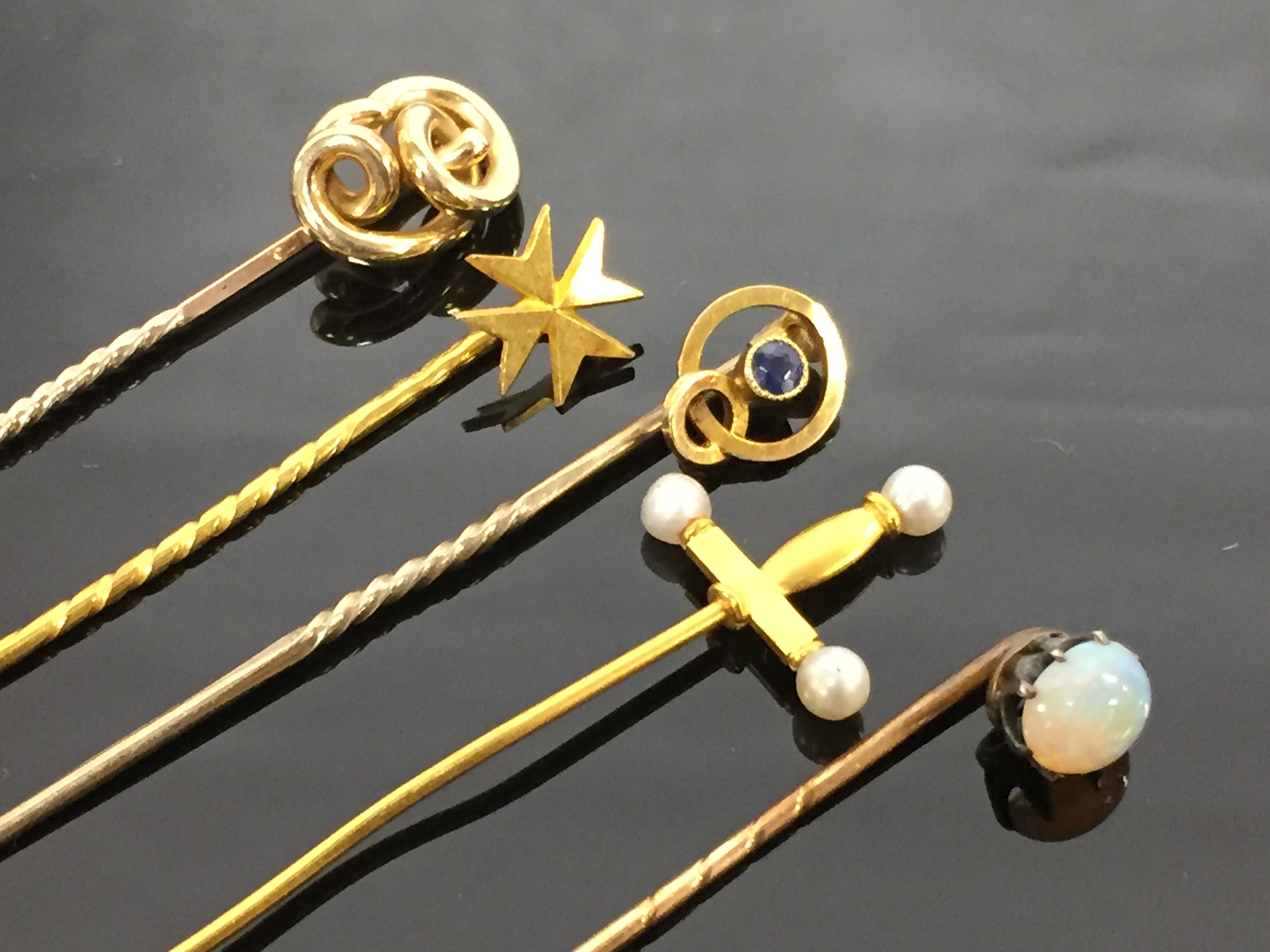 5 GOLD TIE PINS - A KNOT PIN , A SAPPHIRE STUD PIN , A GOLD SWORD AND PEARL TIPPED PIN,