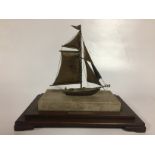 WHITE METAL MODEL OF SAILING BOAT ON MARBLE AND WOODEN PLINTH BEARING LABEL OKOHAMA SHIPYARD AND