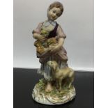 A NAPLES CHINA FIGURE 'SHEPHERDESS WITH A LAMB AND A BASKET OF FLOWERS' 15CM