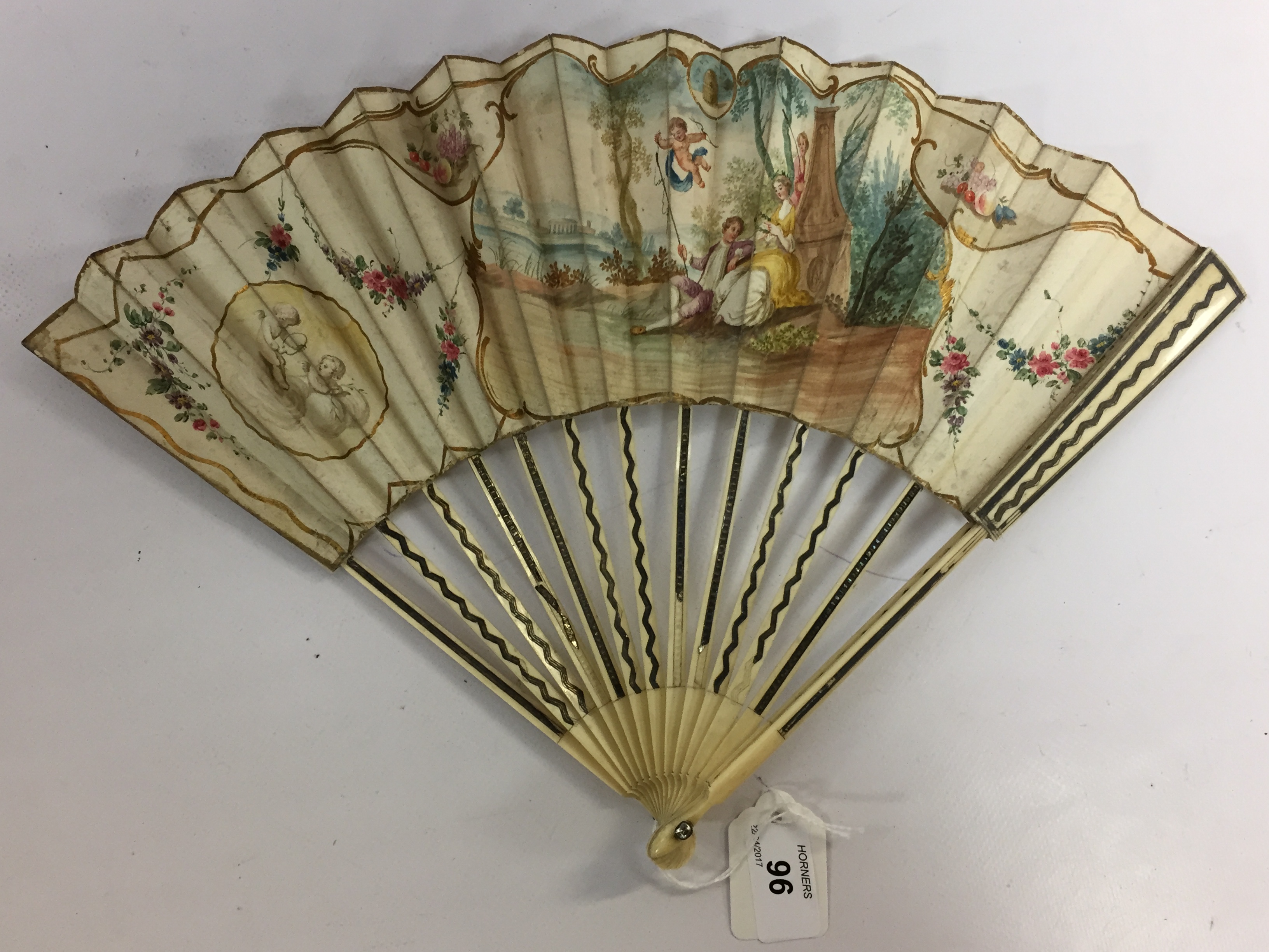 A C19TH FRENCH IVORY FAN WITH SILVER WIRE SPINES, PAINTED WITH ARCADIAN SCENE,