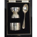 A CHRISTENING SET COMPRISING OF EGG CUP, NAPKIN RING AND TEASPOON,