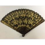 A C19TH CANTONESE BLACK AND GOLD LACQUERED FAN 22.