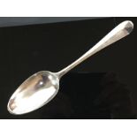 AN EARLY 18TH CENTURY SILVER TABLESPOON THE BACK WITH FOLIATE ENGRAVING AND SCROLLED DESIGN,