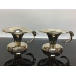 A PAIR OF SILVER CHAMBER STICKS IN ARTS AND CRAFT STYLE,