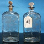 A PAIR OF C19TH CONTINENTAL GLASS SPIRIT DECANTERS WITH WHITE METAL STOPPERS,