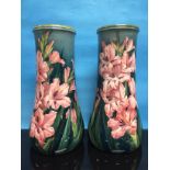 PAIR OF DOULTON LAMBETH FAIENCE VASES (RESTORED) DECORATED WITH GLADIOLI ON GREEN GROUND,