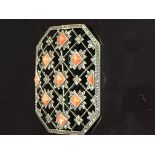 A SILVER BROOCH OF LATTICE DESIGN SET WITH CORAL STONES