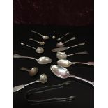 A GROUP OF SILVER FLATWARE TO INCLUDE BRIGHT CUT SUGAR NIPS, SALT AND MUSTARD SPOONS,